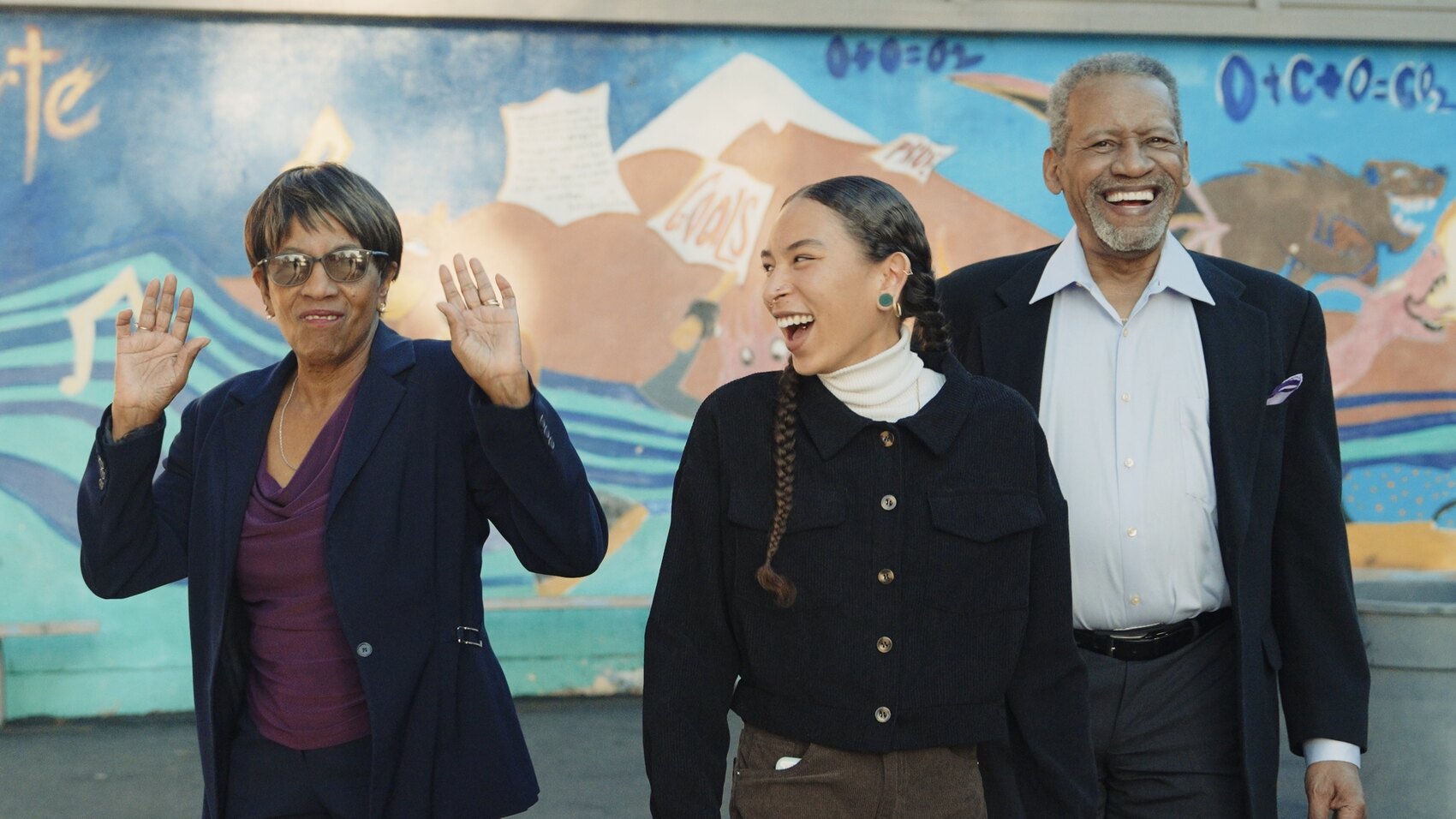 Three community members sharing a joyful moment